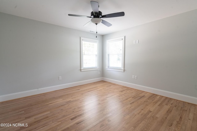 spare room featuring light hardwood / wood-style floors and ceiling fan