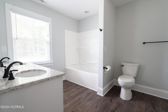 full bathroom with vanity, hardwood / wood-style floors, shower / bathtub combination, and toilet