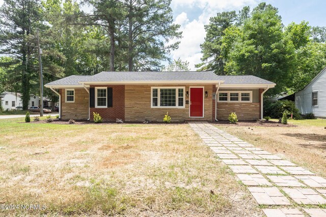 ranch-style house with a front lawn