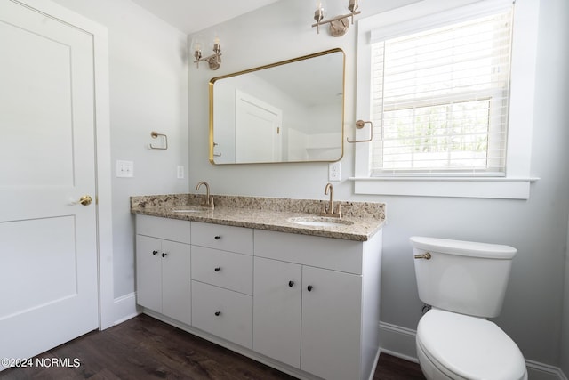 bathroom featuring vanity, toilet, and hardwood / wood-style floors