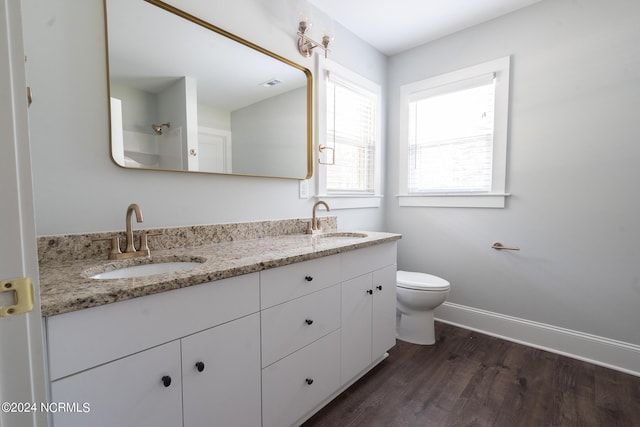 bathroom featuring vanity, hardwood / wood-style floors, and toilet