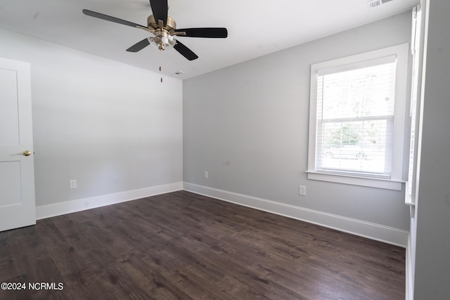 unfurnished room with ceiling fan and dark hardwood / wood-style flooring