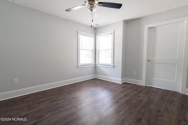 empty room featuring ceiling fan and dark hardwood / wood-style flooring