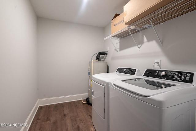 laundry room with dark hardwood / wood-style floors, electric water heater, and washer and dryer