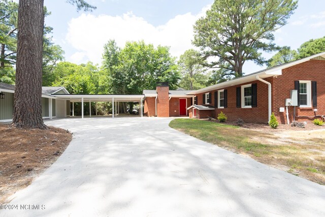 ranch-style home with a carport