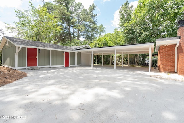 view of parking / parking lot featuring a carport