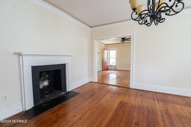 unfurnished living room featuring hardwood / wood-style flooring, ornamental molding, and ceiling fan with notable chandelier