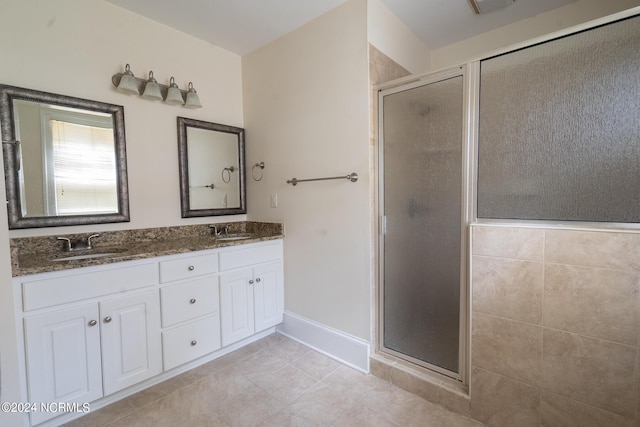 bathroom with vanity, tile patterned floors, and a shower with shower door