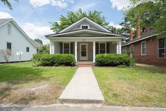 bungalow-style home with a front yard and a porch