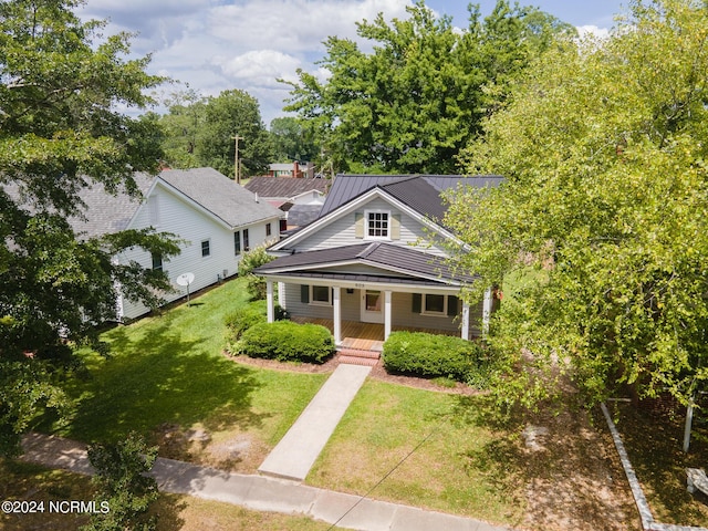 view of front of house with a front yard and covered porch