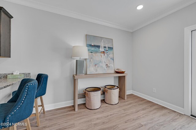 office featuring light wood finished floors, baseboards, ornamental molding, and recessed lighting