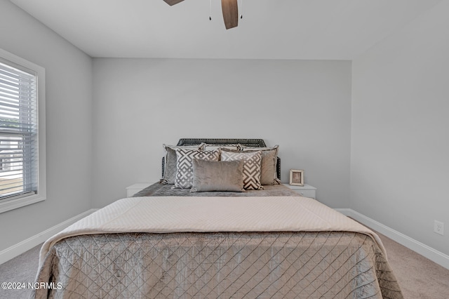 bedroom with carpet flooring, baseboards, and a ceiling fan