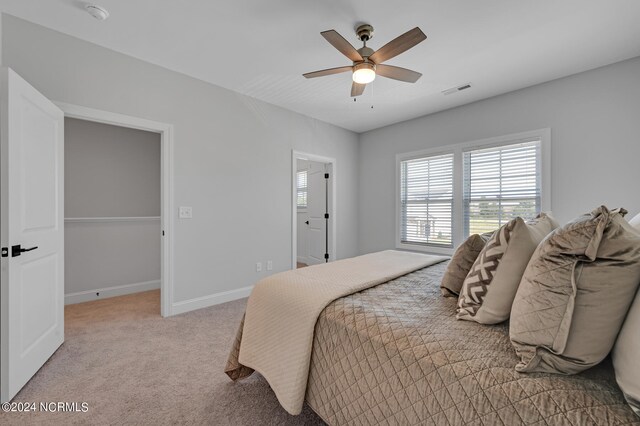 bedroom featuring ceiling fan, visible vents, baseboards, and carpet floors