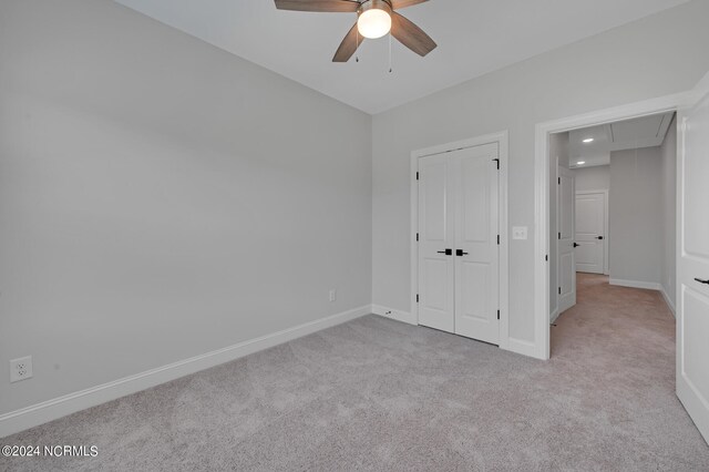 unfurnished bedroom featuring baseboards, recessed lighting, attic access, and carpet