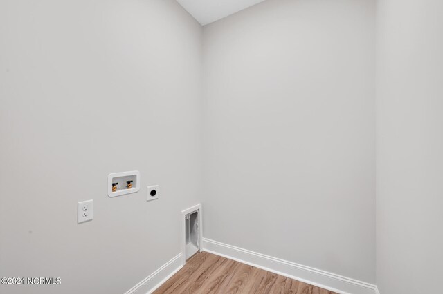 laundry room featuring hookup for an electric dryer, baseboards, light wood-style flooring, washer hookup, and laundry area