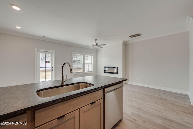 kitchen featuring light wood-type flooring, a fireplace, ceiling fan, sink, and dishwasher