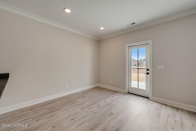 unfurnished room with crown molding and light hardwood / wood-style flooring