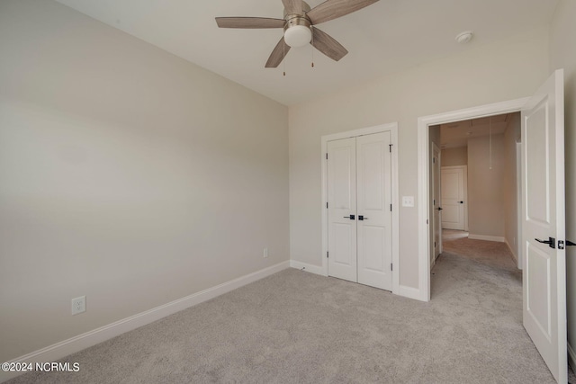 unfurnished bedroom with a closet, ceiling fan, and light colored carpet