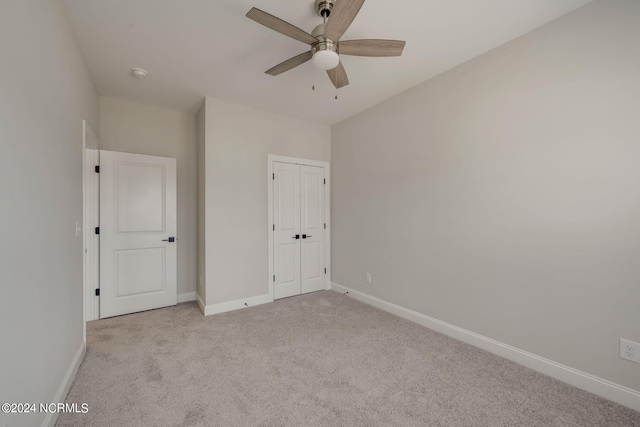 unfurnished bedroom featuring light carpet and ceiling fan