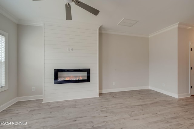 unfurnished living room with ceiling fan, a large fireplace, crown molding, and light hardwood / wood-style flooring