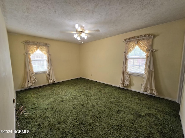 carpeted empty room featuring a textured ceiling, ceiling fan, and baseboards