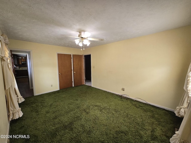 unfurnished bedroom featuring a textured ceiling, ceiling fan, carpet, and baseboards