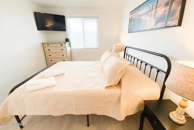 bedroom with wood-type flooring