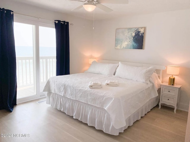 bedroom featuring access to outside, multiple windows, ceiling fan, and light hardwood / wood-style floors