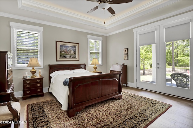 bedroom with access to outside, ornamental molding, wood finished floors, and visible vents