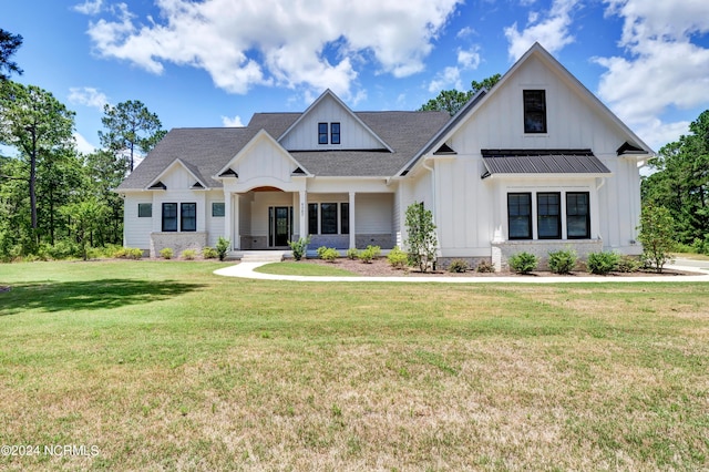 modern farmhouse featuring metal roof, a shingled roof, board and batten siding, a standing seam roof, and a front yard