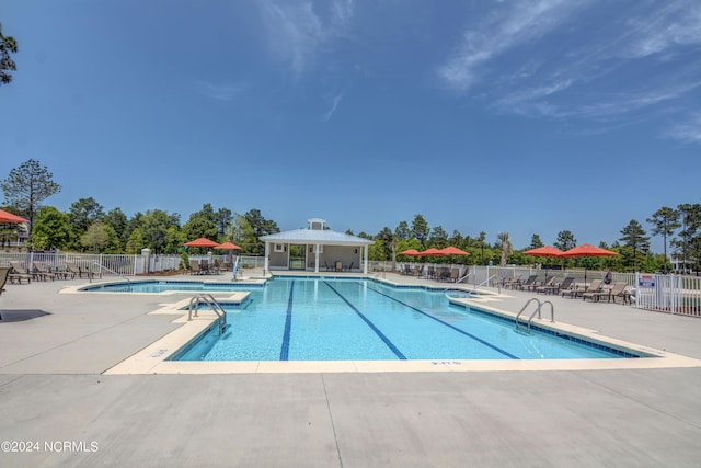 community pool featuring a patio and fence