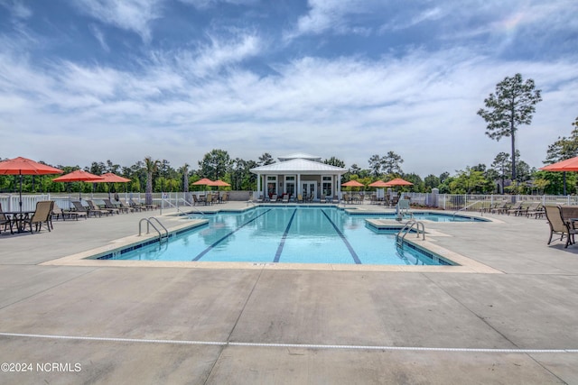 community pool featuring a patio area and fence