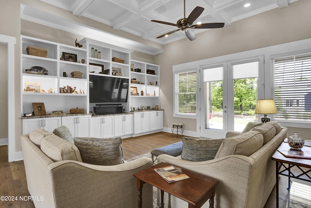 living area with baseboards, coffered ceiling, wood finished floors, french doors, and beam ceiling