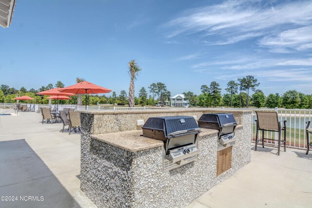 view of patio featuring fence, grilling area, and area for grilling