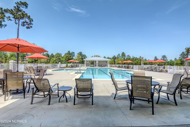 pool featuring a patio area and fence