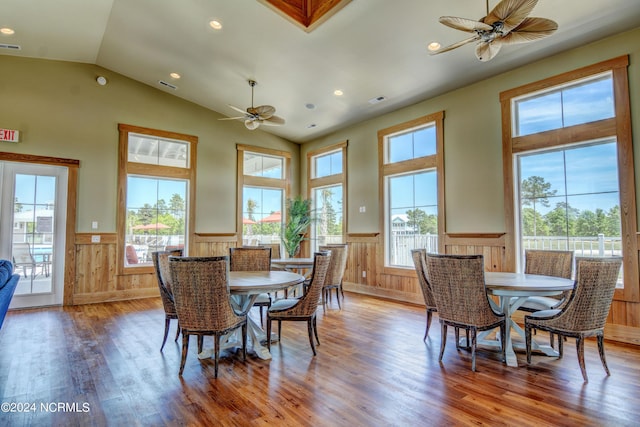 dining space featuring a ceiling fan, a wainscoted wall, and wood finished floors