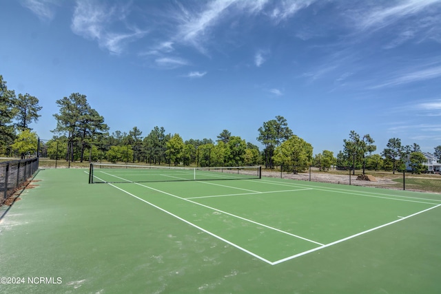 view of sport court featuring fence