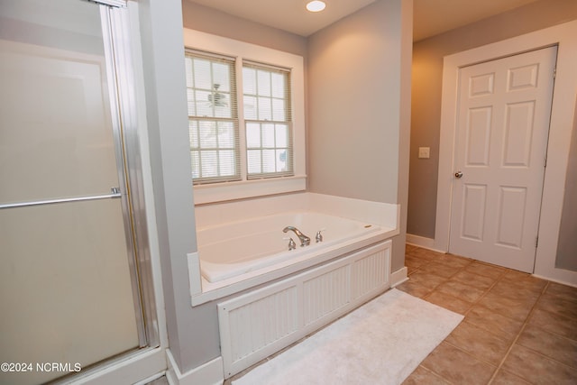 bathroom featuring tile patterned floors and separate shower and tub