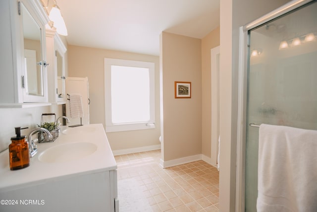 bathroom with tile patterned floors, vanity, and walk in shower