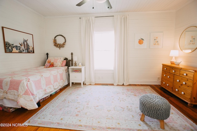 bedroom featuring ceiling fan, wood-type flooring, and ornamental molding