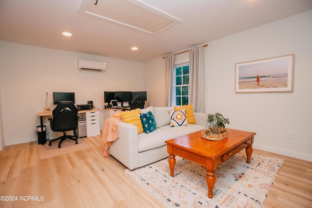 living room with a wall mounted air conditioner and light hardwood / wood-style flooring