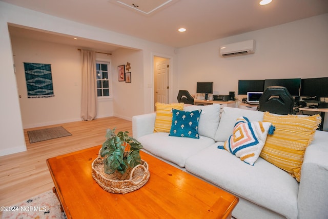 living room with hardwood / wood-style floors and a wall unit AC