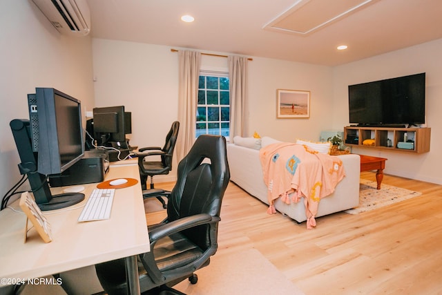 office space featuring an AC wall unit and light wood-type flooring