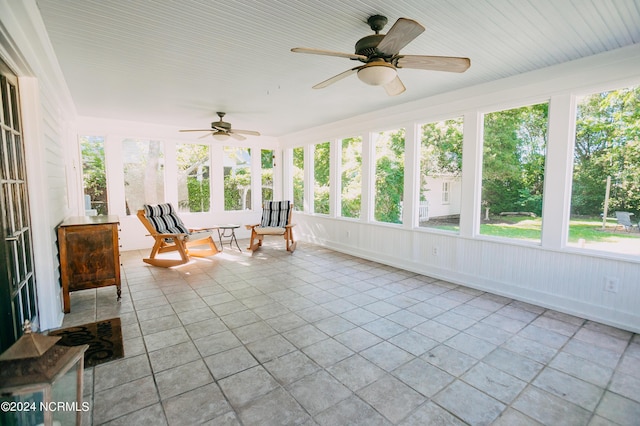 unfurnished sunroom featuring ceiling fan