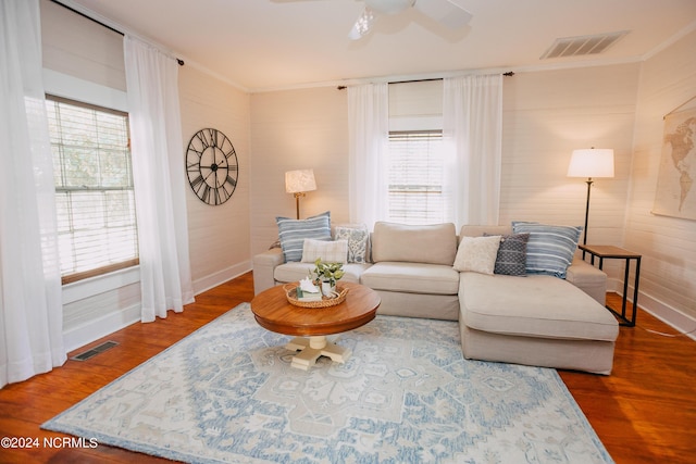 living room with hardwood / wood-style flooring, plenty of natural light, ceiling fan, and crown molding