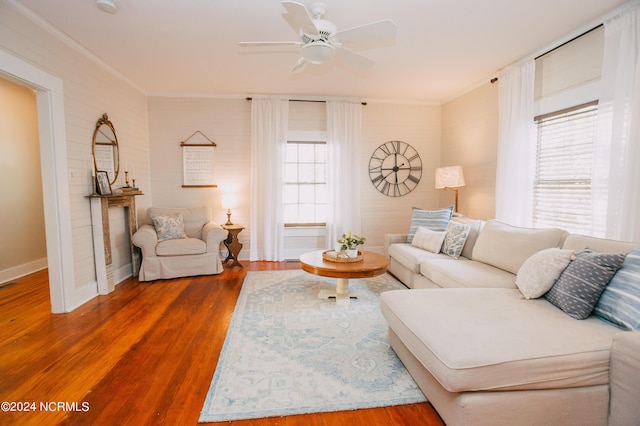 living room featuring plenty of natural light, ceiling fan, wood-type flooring, and ornamental molding