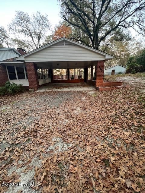 exterior space with a carport and driveway