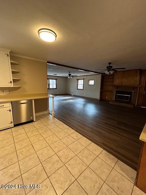 kitchen featuring white cabinetry, ceiling fan, stainless steel dishwasher, light hardwood / wood-style floors, and ornamental molding