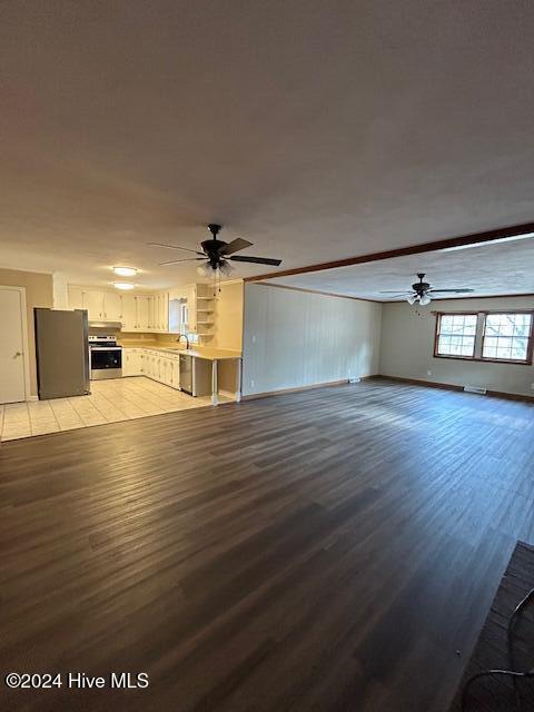 kitchen featuring stainless steel appliances, crown molding, sink, white cabinets, and light tile patterned flooring