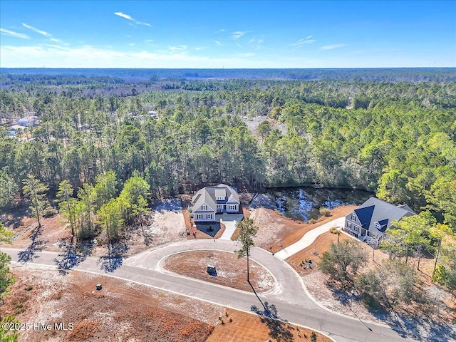 birds eye view of property with a wooded view